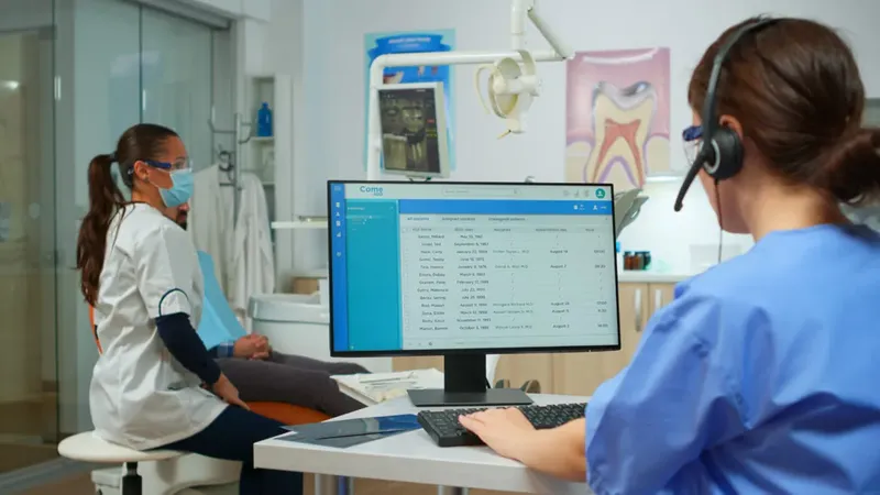 Front office team member working at a computer in a dental practice