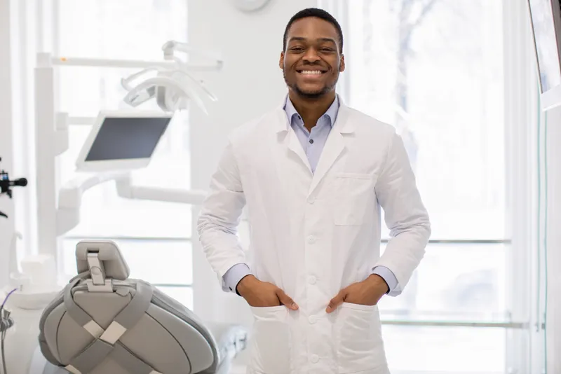 Dentist standing in his treatment room